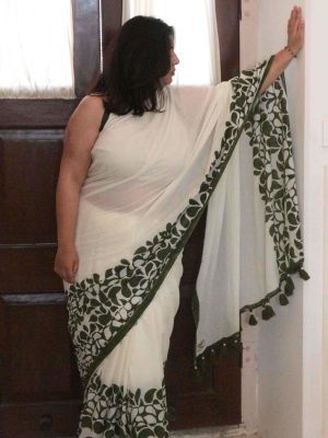 Baawri saree in moonwashed ivory cotton with green abstract drop motifs along the border, minimal green stripe, tassels, and matching blouse.