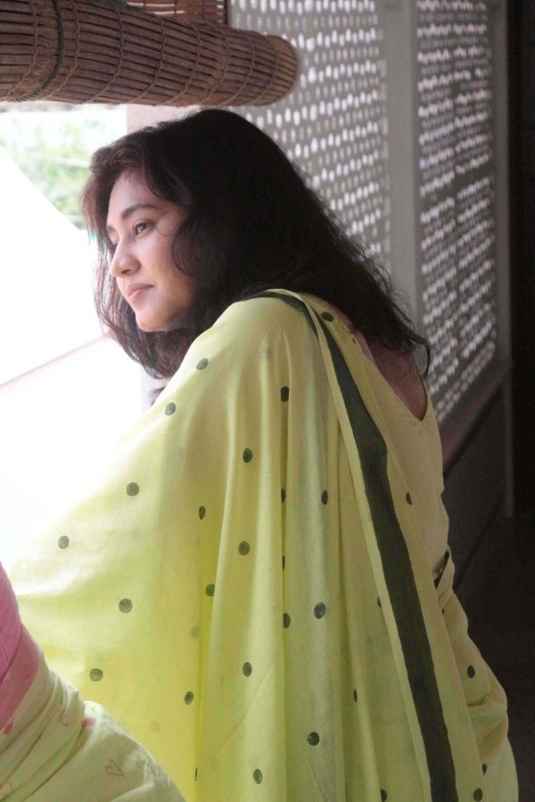 Chhoti Si Baat saree in citrus green cotton with dark green polka dots, dark green border, tassels on the pallu, and matching blouse piece.