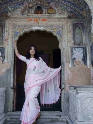 Nazakat saree in soft pink cotton with tulip motifs in pink and green, dark pink border, unique beaded tassels, and matching blouse piece.