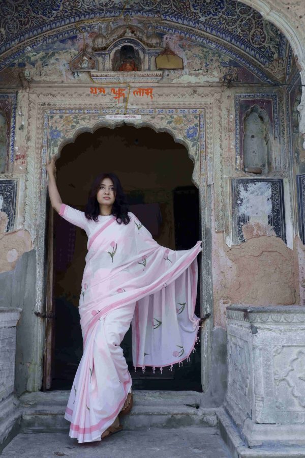 Nazakat saree in soft pink cotton with tulip motifs in pink and green, dark pink border, unique beaded tassels, and matching blouse piece.