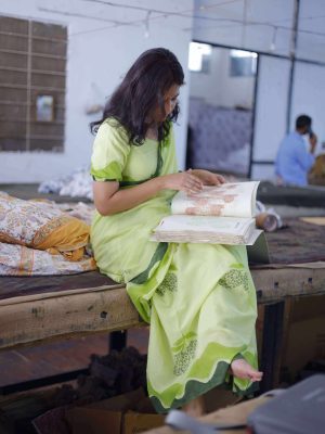Mango Bagh saree in orchard green cotton with floral-filled mango motifs, wide wave border in dark and light green, tassels, and matching blouse piece.
