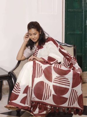 Silsila cotton saree in off-white with maroon semi-circle motifs, maroon striped border, tassels on the pallu, and matching blouse fabric.